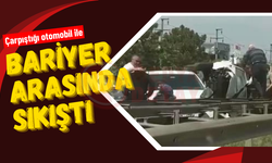 Çarpıştığı otomobil ile bariyer arasında sıkıştı