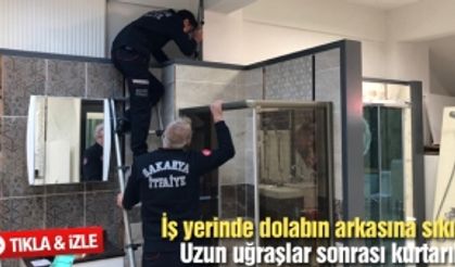 İş yerinde dolabın arkasına sıkıştı!