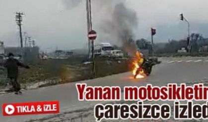 Yanan motosikletini çaresizce izledi