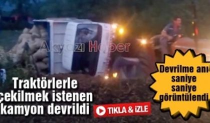 Traktörlerle çekilmek istenen kamyon devrildi