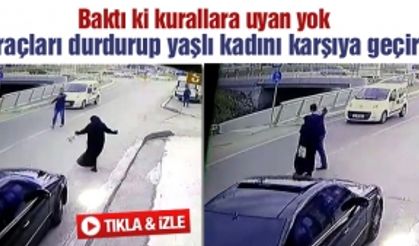 Yaşlı kadını araçları durdurarak yolun karşısına geçirdi