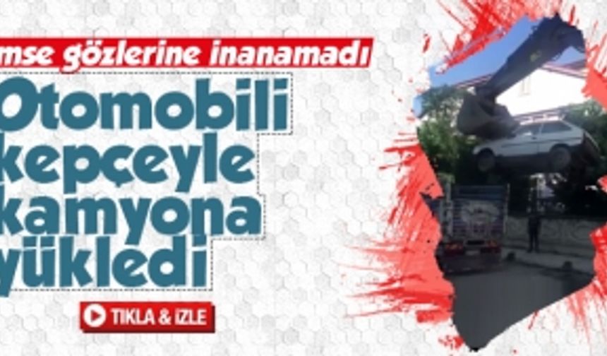 Otomobili kepçeyle kamyona yükledi